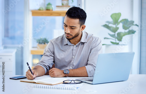 Young business man, writing and book with laptop, notes or schedule planning at web design job. Businessman, notebook and computer with ideas, brainstorming or problem solving for report in workplace