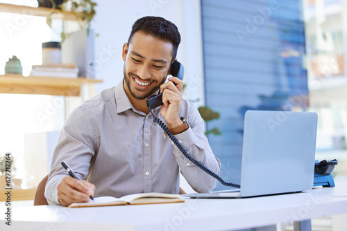 Consultant, businessman on telephone and writing in a notebook with a laptop at desk in office at his workplace. Networking or support, communication and man on a phone call for customer service