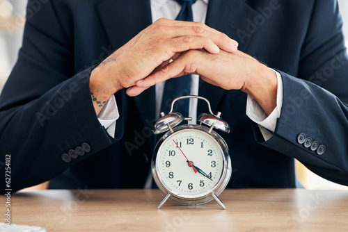 Clock, business man and time management in office for deadline, punctual and busy schedule. Hands of professional person or broker working at desk with alarm, reminder and timer for goals and agenda