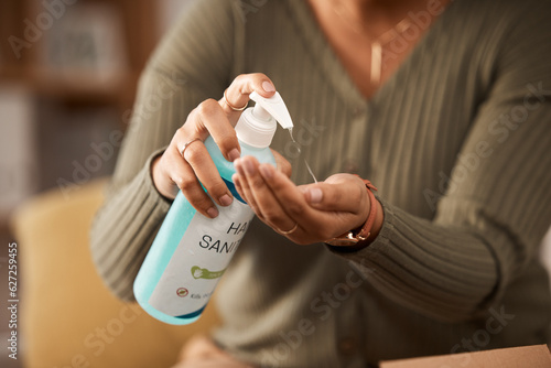 Closeup, hands and a person with sanitizer for medical safety and security from virus in a house. Alcohol, clean and a woman with a bottle of disinfectant liquid in palm for healthcare while sick