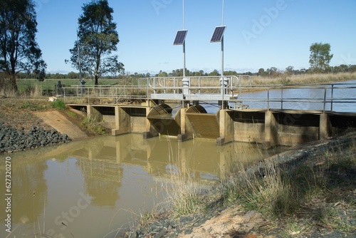 FlumeGate Irrigation water flow regulator and control gates that are remotely controlled and solar powered on a man made channel.