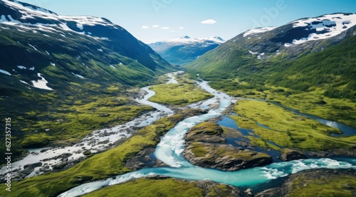 Scenic aerial view of the mountain landscape with a forest and the crystal blue river in Jotunheimen National Park stock photo 