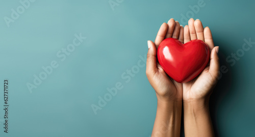 Hand giving red heart , charity symbol