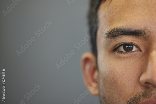 Mockup, portrait and half eyes of a man isolated on a grey background in studio. Serious, Asian and closeup face of a person with space for expression, looking handsome and a young eye on a backdrop