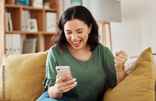 Phone, win and celebration, happy woman on sofa with notification on bonus, deal or discount offer online. Wow, social media and girl on couch with smile, cellphone and excited for surprise in home.