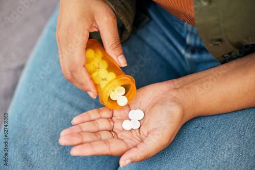 Hands, above and a person with a bottle of medicine for pain, supplement or vitamin c. Closeup, container and a patient with pills, tablet or medical support for mental health, anxiety or virus