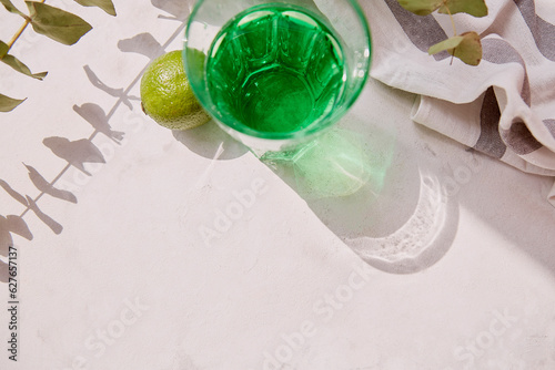 Top view aesthetic lime healthy tarragon detox sparkling cocktail. Non alcoholic vitaminized drink. Green Mocktail for St. Patricks Day. Copy space, 