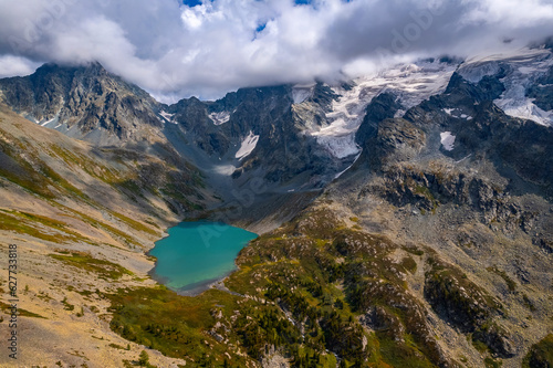 Summer Landscape beautiful mountains Altai with Poperechnoye Multinskoye green lake, Aerial top view
