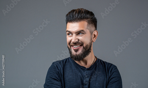 Side view portrait of stylish man. Perfect beard. Bearded man, stylish hairstyle, beard isolated on gray background. Man's haircut in barber shop. Smiling man portrait isolated. People, male beauty