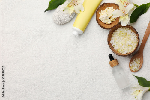 Flat lay composition with spa products and leaves on white towel. Space for text