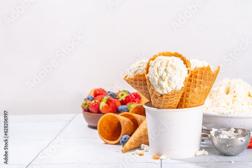 Cottage cheese ice cream, trendy white cottage cheese vanilla ice cream scoops in waffle cones, with fresh berries and toppings 