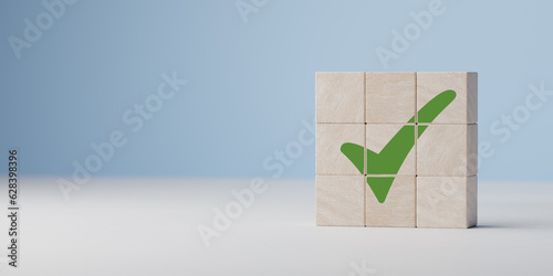Wooden cube with green checkmark icon. Check mark, Check Mark Sign, Tick Icon, right sign,circle green checkmark button, Done. On blue background. Banner. Copy space