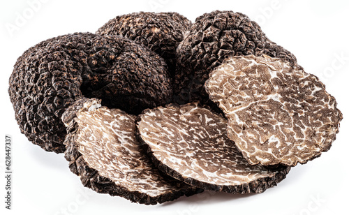 Black edible winter truffle and truffle slices on white background. The most famous of the truffles.