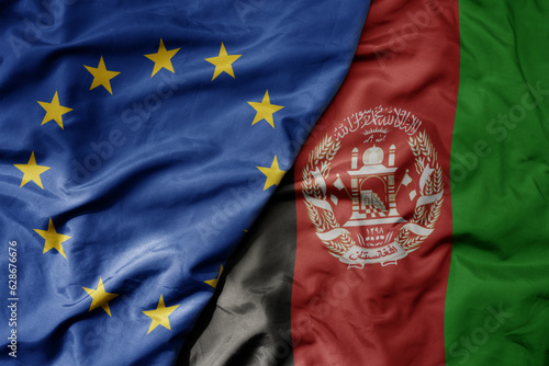 big waving realistic national colorful flag of european union and national flag of afghanistan .