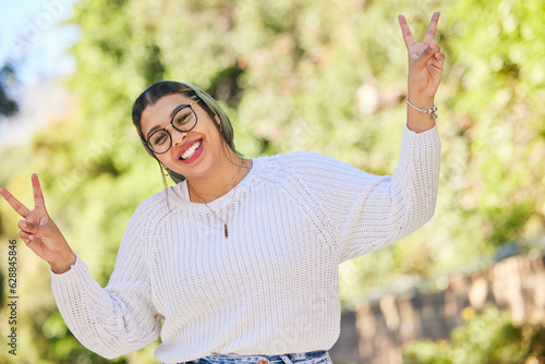 Peace sign, woman and portrait with a smile outdoor of student on summer holiday and vacation. Motivation, gen z and emoji v hand gesture feeling silly with freedom and female person from Morocco