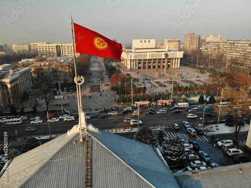 Kyrgyzstan flag near theatre in Bishkek at winter time. High quality photo