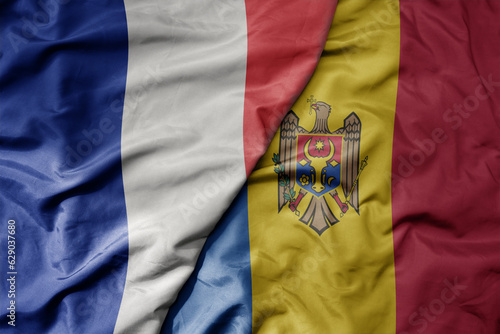 big waving realistic national colorful flag of france and national flag of moldova .
