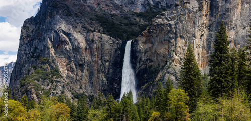 Panorama of Bridalveil Fall from Yosemite Valley viewpoint on Northside Drive pullout in Yosemite Valley, Yosemite National Park, California, USA in May of 2023 