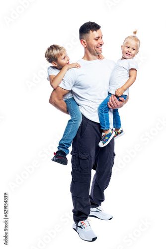 A man stands with children in his arms. Smiling dad with little daughter and son are hugging and laughing. Love and tenderness. Isolated on white background. Full height. Vertical.