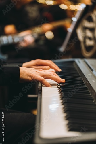 Closeup shot of the hands of a pianist on a piano.