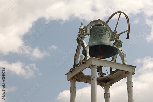 Old church bell standing a background the blue sky, Church Assumption Rosbercon New Ross Ireland.