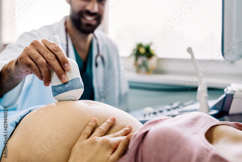Cropped shot of a pregnant woman during ultrasound scanning at the hospital, clinic.