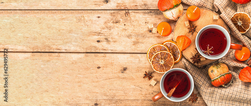 Spicy hot tea. Autumn good mood, traditional fall beverage in cups. Pumpkin, scarf, candles
