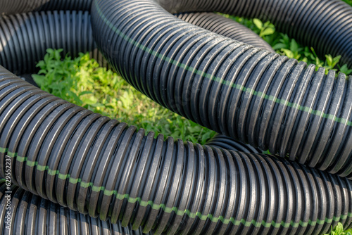 Black storm water underdrain pipe used to mitigation ground water. Abstract rounded shape.