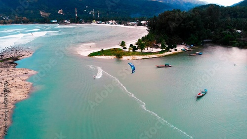 Approaching frame of kiteboarding at shallow in lagoon. Authentic happiness to feel free when riding on kitesurfing in wild ocean. Come to ocean, ride on kitesurfing and feel authentic happiness.