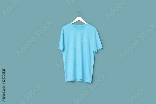 Stylish t-shirt hanging on blue background