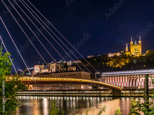 View of footbrige over Saone river and Vieux Lyon by night in Lyon, France