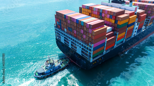 Stern of large cargo container ship import export container box on the ocean sea on blue sky back ground concept transportation logistic and service to customer and supply change..