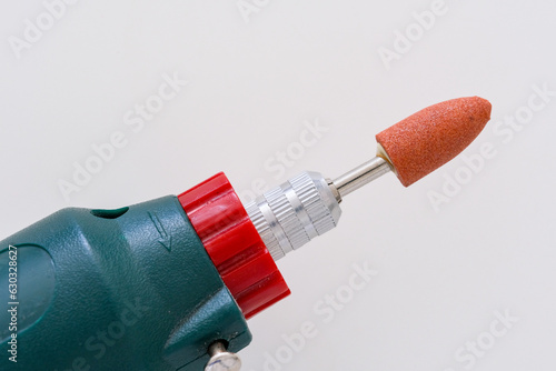 Mini Drill or Electric rotary tool plugged with grinding head