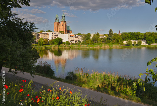 Gniezno town in summer, Poland. The architecture of the city with the dominant Primate's Basilica reflects in the waters of Lake Jelonek. 