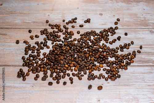top shot of fresh coffee beans standing on wooden background. Coffee bean and coffee varieties. Close-up and high definition image of raw coffee beans.