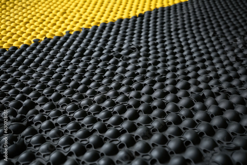 An up-close view of industrial safety mats made of durable rubber and featuring raised bumps for better grip and anti-slip protection