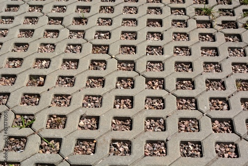 Concrete openwork plates used as garden road and parking lot for cars