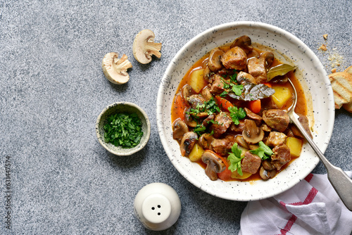 Meat stew ( beef bourguignon ) with vegetable and mushrooms. Top view with copy space.
