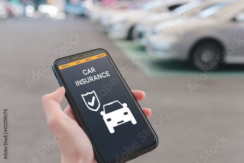 Hand using mobile phone device to access an online car insurance platform customers can compare quotes, With this innovative solution, file claims, and access roadside assistance right.