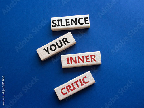 Silence your inner critic symbol. Wooden blocks with words Silence your inner critic. Beautiful deep blue background. Business and Silence your inner critic concept. Copy space.