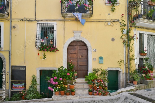 The facade of a house decorated with flowers and plants in Buccino, a medieval village in the province of Salerno, Italy.
