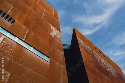 Facade of European Solidarity Centre building, Europejskie Centrum Solidarnosci in Gdansk Poland. Exterior on blue sky background. Abstract building wallpaper Monument to the fallen Shipyard Workers