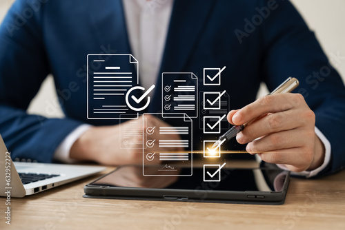 Business performance monitoring concept, businessman using tablet and laptop Online survey filling out, digital form checklist, blue background.