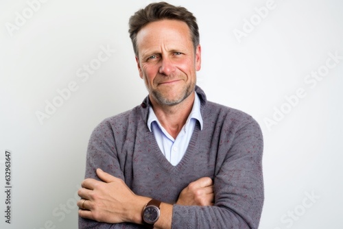 Medium shot portrait photography of a man in his 40s scratching his arm due to atopic dermatitis wearing a chic cardigan against a white background 