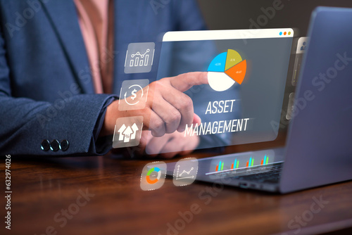 Asset management concept, Man using laptop with word asset management and Icon on virtual display. Financial Property Digital assets.