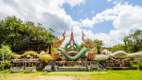 Ubon Ratchathani, THAILAND - August 8, 2023: Buddhist travel glowing serpent statue with sunlight at Wat Pa Phu pang temple, Si Chiang Mai District, Ubon Ratchathani Province, Thailand.