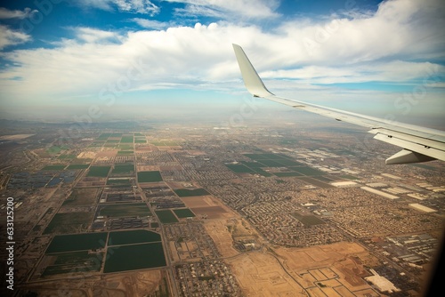 Aerial photo of the surban sprawl and agriculture areas south of Phoenix Arizona, wing of airplane in photo