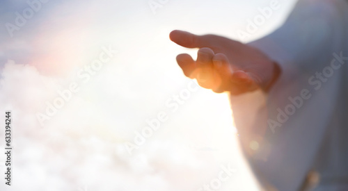 Jesus Christ with open arms reaching out in the sky, hand gestures of Jesus dying on the cross and resurrected, heaven and salvation, faith and love, easter concept 