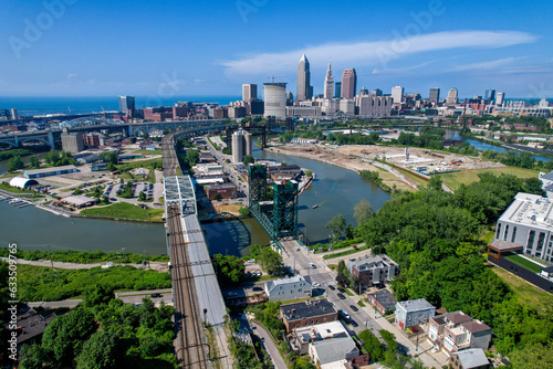 An aerial view of downtown Cleveland, Ohio with the Cuyahoga River in snaking through, including the rail lift brifge.