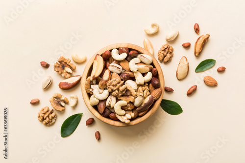 mixed nuts in bowl. Mix of various nuts on colored background. pistachios, cashews, walnuts, hazelnuts, peanuts and brazil nuts